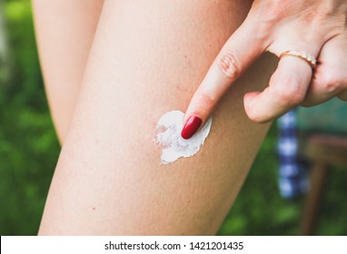 Mosquito bite the leg  Insects in the summer  Dangerous nature  Itchy body  Girl is applying cream the swell skin  Medical treatment for first aid 