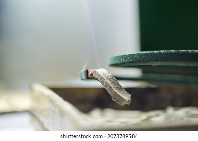 Mosquito Coils. Macro Photography Of Coiled Mosquito Coils With Thin Smoky Red Embers In A Room