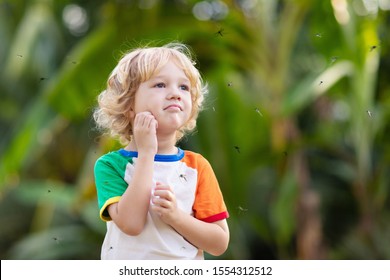 Mosquito On Kids Skin. Little Boy Attacked By Mosquitoes In Tropical Forest. Insect Repellent. Malaria And Dengue Fever Prevention. Child Scratching Itchy Bite In Summer Park.