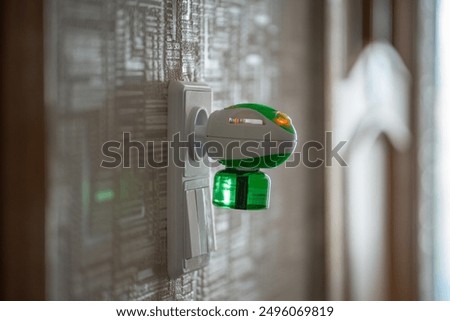 Mosquito repellent with plug into the socket at home closeup. Domestic electric raptor fumigator for mosquitoes protection. Insect repellent diffuser. 