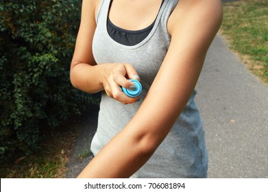 Mosquito Repellent Spray. Woman Spraying Insect Repellent Against Bug Bites On Arm Skin Outdoor In Nature Forest Using Spray Bottle.