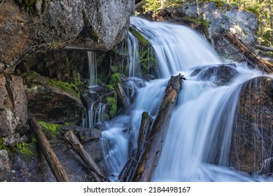 Moss grows in the shadow of a huge boulder near the tp of the Calypso Cascades in Wild Basin, Rocky Mountain National Park, Colorado. - Powered by Shutterstock