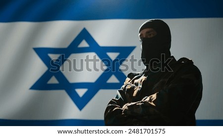 Mossad intelligence corps agent standing proud in front of Israel flag, feeling pride in serving country. Close up shot of Israeli counterintelligence operation spy in war room crossing arms, camera B