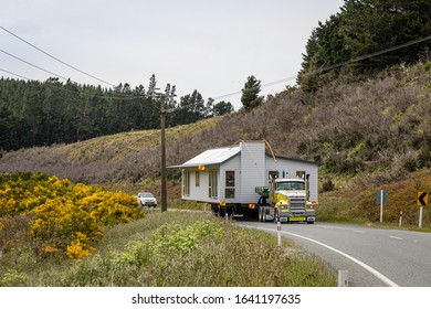 Mossburn, Southland, New Zealand - 16 December 2019: An Oversized Transport For The Relocation Of A Whole House Is Driving Along New Zealand State Highway 94.