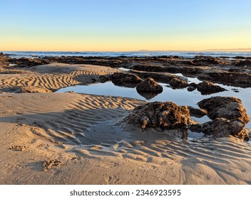 Mossy Boulders in the Ocean Ripples in the Sand - Powered by Shutterstock