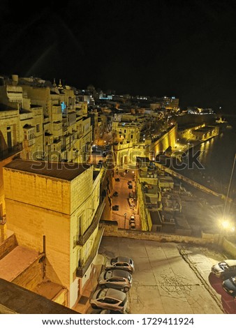 Similar – On the left, part of Gaeta Cathedral (Italy) On the right, an old building and the silhouette of an umbrella line. In between the view of the old town and the port of Gaeta.