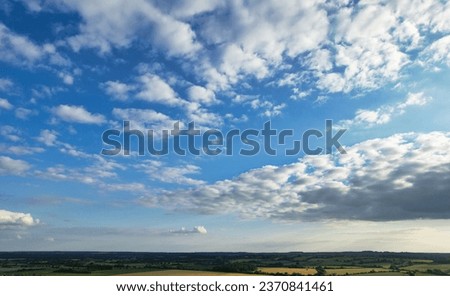 Most Beautiful and Best High Angle View of Dramatic and Thick Clouds and Blue Sky over British Countryside at Sharpenhoe Clappers Near Luton City of England UK. June 6th, 2023 During Sunset Time