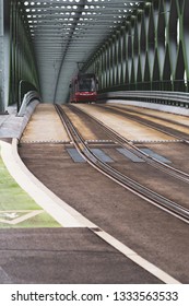 Starý Most Bridge In Bratislava Slovakia, As Red Tram Approaches. 