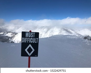 Most Difficult Black Diamond Sign On Snowboarding Snowboard Skiing Ski Hill Mountain With Snow In Background