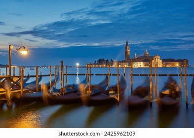 The most popular and romantic place in Venice. Gondolas moored at St. Mark's Square with the Church of San Giorgio di Maggiore in the background at sunset dawn, Venice, Italy. - Powered by Shutterstock