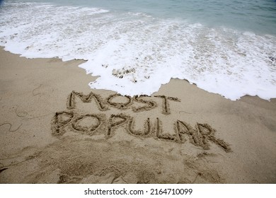 MOST POPULAR. The Words Most Popular written in the sand. Laguna Beach, California with the Pacific Ocean and the words Most Popular written in the sand. Laguna Beach is one of the Most Popular. 