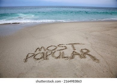 MOST POPULAR. The Words Most Popular written in the sand. Laguna Beach, California with the Pacific Ocean and the words Most Popular written in the sand. Laguna Beach is one of the Most Popular. 