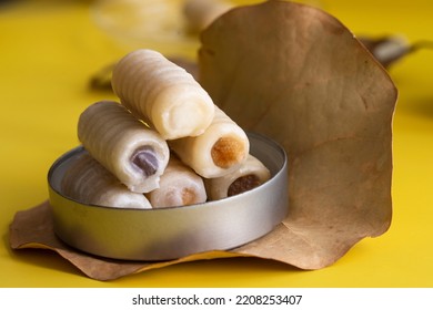 The Most Traditional Of Spanish Mazapan Sweets Huesos De Santo  On Yellow Background. All Saints Day Food Modern Concept.