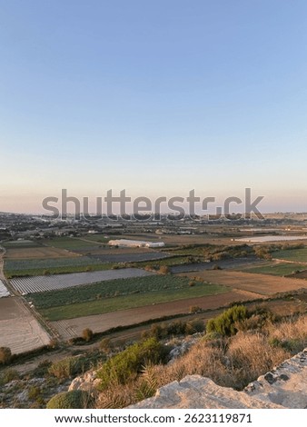 In Mosta, Malta, the view opens to fields dotted with small cultivated plots, showcasing the island’s quiet agricultural countryside. 20 OCT 2022