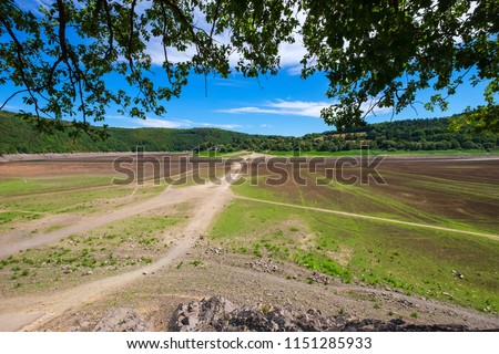 The mostly dried up Lake Eder in North Hesse/Germany with the surfaced bridge of Asel in the background Stock photo © 