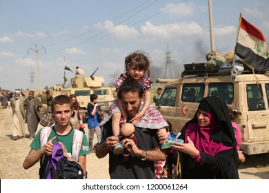 Mosul, Iraq - May 5,2017: A Displaced Family Flees From Mosul, ISIS Caliphate Territory, During Coalition Advance Into The Northwest Of The City.