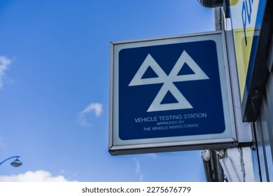 MOT vehicle testing station against blue sky with clouds background, transport and travel concept illustration.