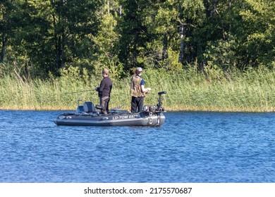 Motala Sweden July 2022
Two Guys Fishing From A Small Inflatable Boat.