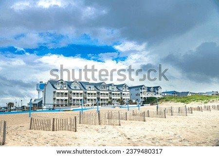 Motel and beach on the Atlantic Ocean under a cloudy sky.