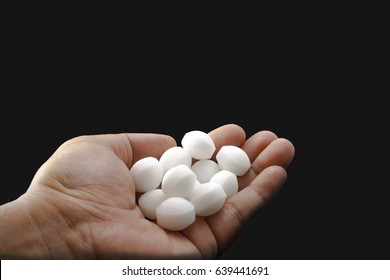 Moth Balls On The Male Hand.