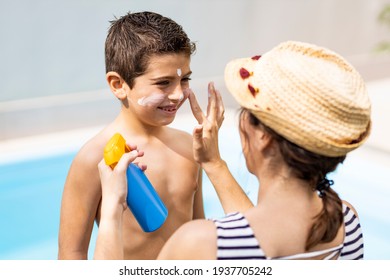 Mother aplying sunscreen to her son on a summer day - Powered by Shutterstock