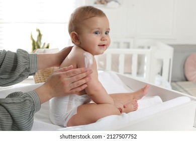 Mother applying body cream on her little baby at home, closeup - Shutterstock ID 2127507752