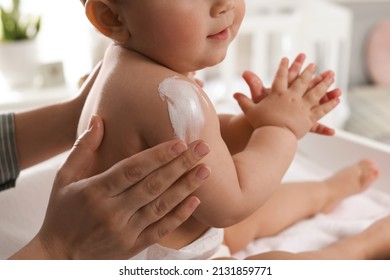 Mother applying body cream on her little baby at home, closeup - Shutterstock ID 2131859771