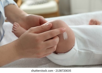 Mother applying body cream on her little baby indoors, closeup - Shutterstock ID 2138720035