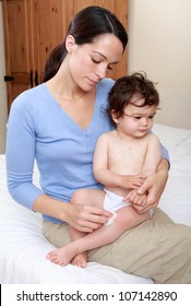 Mother Applying Cream To Stop Itching