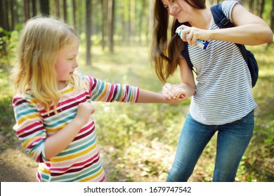 Mother Applying Insect Repellent To Her Daughter Before Forest Hike Beautiful Summer Day. Protecting Children From Biting Insects At Summer. Using Bug Spray. Active Leisure With Kids.