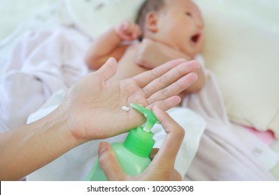 Mother Are Applying A Lotion Cream On The Baby Body After Bath. Baby Care Concept.