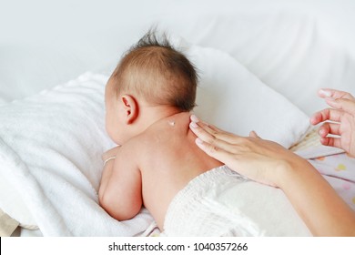 Mother Are Applying A Lotion Cream On The Baby Body After Bath.