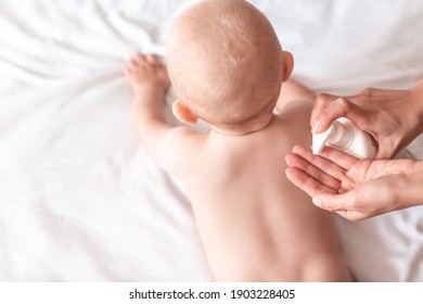 Mother Are Applying A Lotion Cream On The Baby Body After Bath. Changing The Baby Nappy In Nursery. Massage For Baby. Concept Cleaning Wipe, Pure, Clean.