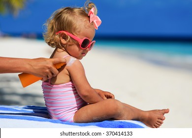 mother applying sunblock cream on daughter shoulder - Powered by Shutterstock