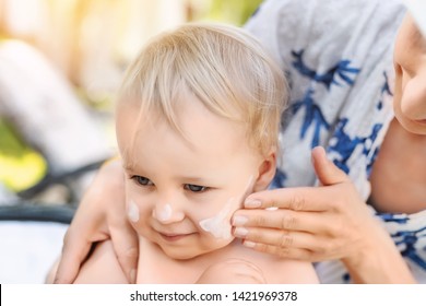 Mother Applying Sunscreen Protection Creme On Cute Little Toddler Boy Face. Mom Using Sunblocking Lotion To Protect Baby From Sun During Summer Sea Vacation. Children Healthcare At Travel Time