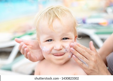 Mother Applying Sunscreen Protection Creme On Cute Little Toddler Boy Face. Mom Using Sunblocking Lotion To Protect Baby From Sun During Summer Sea Vacation. Children Healthcare At Travel Time