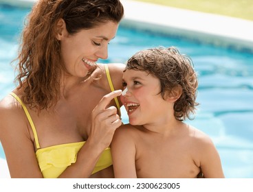 Mother applying sunscreen to son's face - Powered by Shutterstock