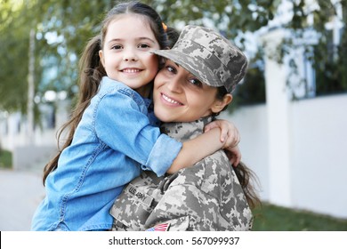 Mother in army uniform and daughter in the street - Powered by Shutterstock