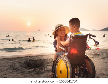 Mother and Asian special child on wheelchair is happily on the beach,Mom and son spend holiday to travel and learning about nature around the sea,Life in the education age, Happy disabled kid concept. - Powered by Shutterstock