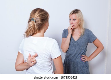Mother asking her teenage daughter. Girl wants to lie to her parent and crossed her fingers.
