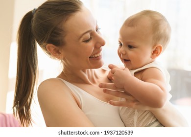 Mother and baby close-up. Mom holds the child in her arms, hugs him and kisses him. Happy family concert. High quality photo