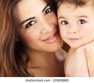 Mother and baby closeup portrait, happy faces, Arabic family picture, adorable small boy, mom and kid having fun indoor, parents joy, holding little child, healthy toddler and mommy, happiness concept - Powered by Shutterstock