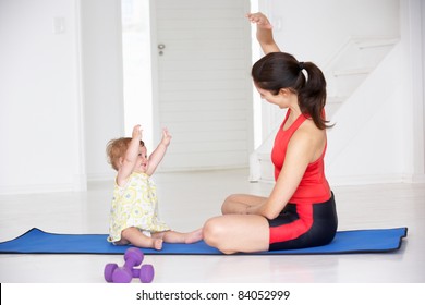 Mother and baby doing yoga