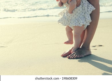 Mother And Baby Feet At The Beach Sand