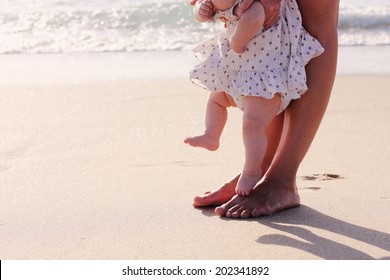 Mother And Baby Feet At The Beach Sand