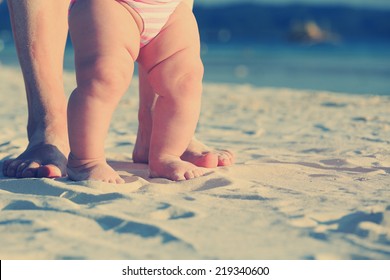 Mother And Baby Feet Walking On Sand Beach