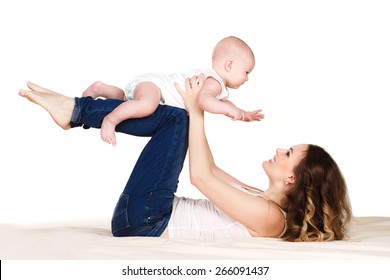 Mother With Baby. A Mother And Baby Gymnastics, Yoga Exercises Isolated On White Background. Beautiful Mom With Her Cute Baby Having Fun Together