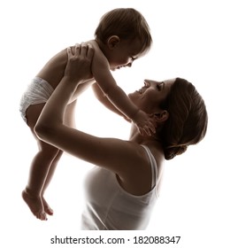 Mother And Baby, Happy Family Raising Up Smiling Child, Isolated Silhouette On White Background. 