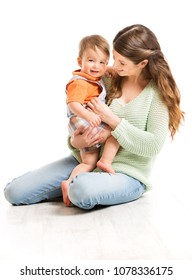 Mother And Baby, Happy Mom With Child One Year Old Sitting On Floor, Family Isolated Over White Background