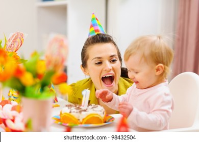 Mother and baby having fun at birthday party